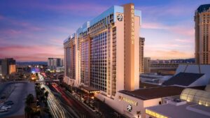 Exterior shot of a narrow hotel on the Las Vegas strip at dusk